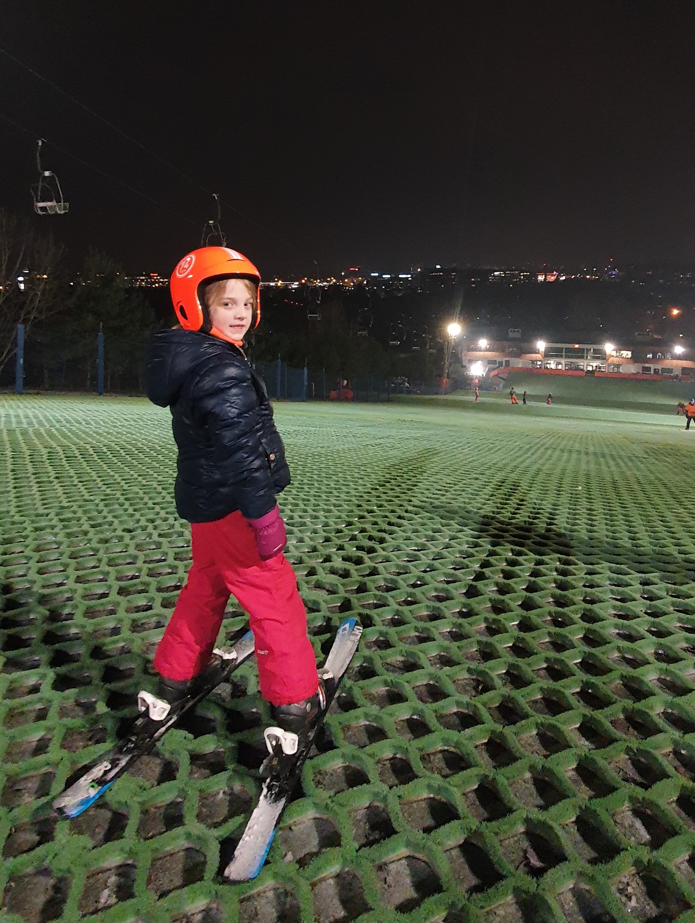 A young skier at the top of the hill